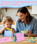Kids 21-piece kitchen knife set with pink cutting boards and colorful plastic utensils (front view)