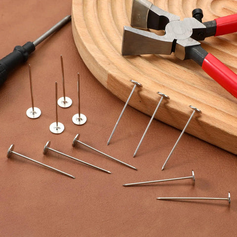 Top Shelf Long Thumb Tacks And Heavy Duty Push Pins, Flat Head Furniture Tacks For Sofa And Headboard Decor, Silver Finished Upholstery Nails Straight Up Diy Essential With Knockout Hold And Quick Install with tools on wood and leather surface.