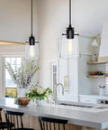 Black Pendant Lights For Kitchen Island, Modern Glass Hanging Fixture with thickened shade in a bright kitchen.