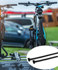 8 Piece Cradle Ratchet Strap Kit For Bike Racks And Roof Carriers, securing bikes on a car roof in a campsite setting.