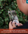 Child holding Liquid Filled Compass Kit For Hiking With Trail Ready Rotating Bezel, Quick Tip Guide, And Carabiner outdoors
