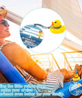 Woman on deck chair with 180 Pack Cruise Duck Party Decor Kit tag attached to blue lanyard, showing yellow rubber duck.