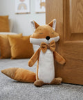 Fox Shaped Plush Door Stopper With Cotton Filling, Heavy Duty Proofing Pinch Guard next to a closed wood door in a cozy room.