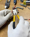 Close-up of BOOSDEN 6.5-inch wire cutters with yellow handles held by gloved hands