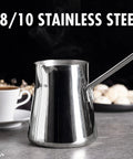 Go-To Turkish Coffee Pot Cezve Ibrik Briki Stainless Steel Stove Top Pot For Turkish Arabic Greek Brews, 500 ml, beside a teacup.