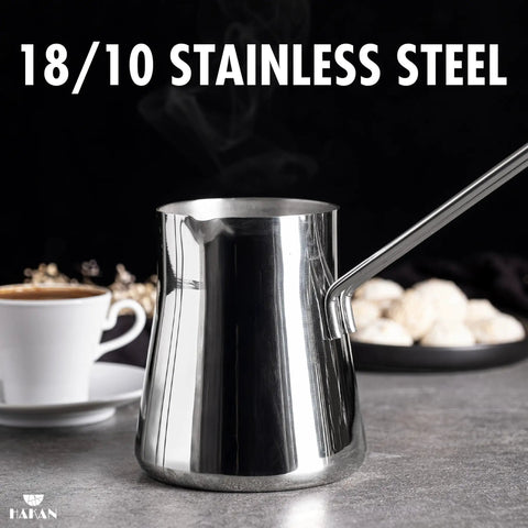 Go-To Turkish Coffee Pot Cezve Ibrik Briki Stainless Steel Stove Top Pot For Turkish Arabic Greek Brews, 500 ml, beside a teacup.