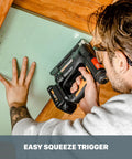 Man using Nitro 20V Cordless Crown Stapler with Air Impact Technology on wooden frame, easy squeeze trigger shown
