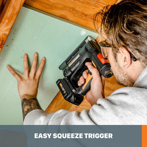 Man using Nitro 20V Cordless Crown Stapler with Air Impact Technology on wooden frame, easy squeeze trigger shown