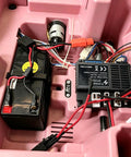 Interior view of ride-on car with 12V JR1922RXS Receiver, 2.4G Bluetooth Remote Control Box Kit, battery, and wiring inside.