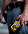 Person holding a Rhino 5200 Label Maker With One Touch Hot Keys For Speedy, Durable Asset Labeling On Job Sites