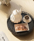 Smooth Spinning Nine Inch Solid Wood Lazy Susan Turntable With Wide Slip Resistant Base And Heavy Duty Spin Mechanism For Kitchen Cabinet Table Top Organization Total Game Changer with teapot, coffee, and croissant.