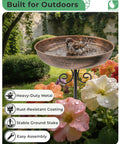 Durable Metal Bird Bath With Stake, 10 Inch Diameter Bowl, 0.4 Gallon Capacity, in a garden setting with blooming flowers.
