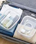 Hella Durable Clear Hard Shell Zipper Cases 6 Pack Water Resistant Storage Pouches For Travel with toiletries and charger in suitcase.