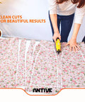 Slick Cordless Electric Fabric Scissors And Heavy Duty Cardboard Cutter With Two Swappable Blades cutting floral fabric for sewing.