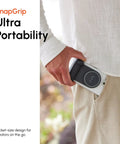 Person sliding SnapGrip Pro Phone Camera Grip And Magnetic Power Bank With Qi2 Wireless Charging into pocket