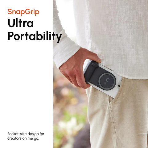 Person sliding SnapGrip Pro Phone Camera Grip And Magnetic Power Bank With Qi2 Wireless Charging into pocket
