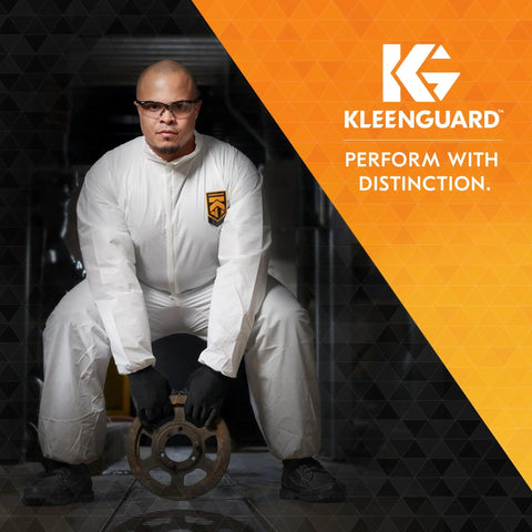 KleenGuard V30 Nemesis polarized safety glasses with smoke-grey lenses and gunmetal frame worn by a person in a suit.