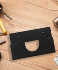 Black Iron Angle Grinder Holder Rack for Garage and Workshop Wall Mount Tool Organizer on wooden surface with tools