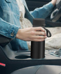 Person placing Stainless Steel Water Bottle With Filter That Delivers Fresher Tasting Water On The Go GoZero in car cup holder