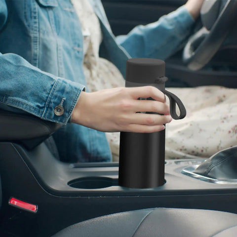 Person placing Stainless Steel Water Bottle With Filter That Delivers Fresher Tasting Water On The Go GoZero in car cup holder