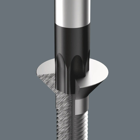Close-up of a drill bit penetrating solid metal, showing cutting edges and spiral grooves on a grey background.