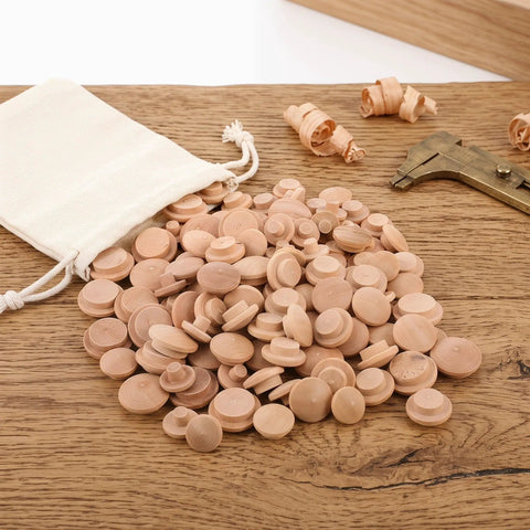 120Pcs Wood Screw Hole Plugs With Top for Wooden Furniture Hole Covers scattered on a wooden surface, bag in background
