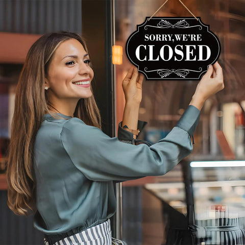 Woman hanging 'Closed' side of Waterproof Double Sided Open Or Closed Sign For Business With Rope Hanging Sign 11.8 By 7.9 Inches