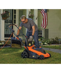 Man using 20 Inch Corded Electric Lawn Mower With 13 Amp Motor Ultra Light No Sweat Push Design 3 In 1 Mowing Versatility