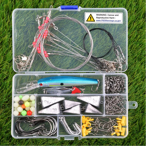 136 Piece Saltwater Tackle Kit For Surf Fishing With Lures And Rigs Hooks Leaders Swivels Sinker Weights Beads Snaps And More All In One Ocean Fishing Gear displayed in a clear plastic box on grass.