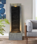 7-Tier Rock Water Fountain With Lights For Outdoor Garden Decor, shown indoors with cascading waterfall and warm LED lights