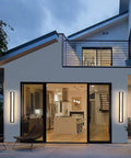 Modern house with Dope Outdoor Wall Light 20W LED Exterior Fixture, 31.5 Inch IP65 Waterproof Sconce illuminating patio doors.