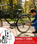 Man using All In One Bike Repair Gear Kit For Mountain Bikes 9 Piece Set with tools next to a parked bicycle outdoors.