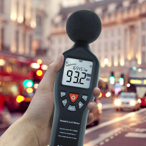 Go-To Portable Decibel Meter With Data Logger, 30 To 130 dB Range, SPL Meter display in city street setting.
