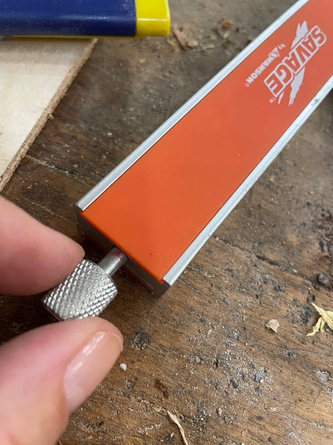 Close-up of the 9 Inch Savage T Bevel with stainless steel rule and secure metal knob for precise angles, woodworking tool on table.