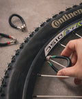 Vinyl Coated Bike Spoke Wrench With Heat Treated Steel For 80 Gauge Spokes Color Coded Handles in use on bike wheel