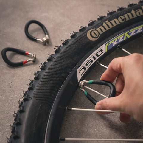 Vinyl Coated Bike Spoke Wrench With Heat Treated Steel For 80 Gauge Spokes Color Coded Handles in use on bike wheel