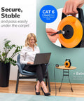Woman using laptop with Flat Retractable CAT6 Ethernet Cable Extender, 50 Feet UTP Reel, shown in use, offering quick setup.