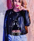 Woman wearing Rock Rivet Belt With Pyramid Studs, edgy punk studded belt, black metal grommet belt for everyday street style.