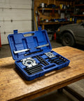 Thinking Process: 14-piece metal bearing puller kit in blue plastic case on garage workbench
