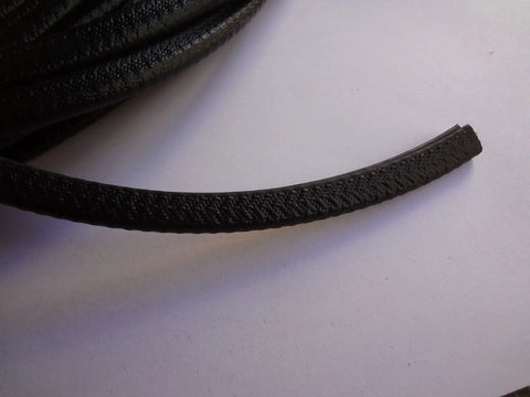 Close-up of Black Trim Guard 1/16 Inch Thick 15 Feet Long Easy Install Edge Protector showing texture and curved design.