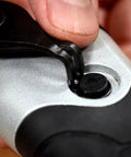 Close-up of snap ring pliers in use, part of the Beast Of A 10 Piece Snap Ring Pliers Set For Internal And External Rings With Heat Treated Chrome Molybdenum Steel And Comfortable Insulated Vinyl Handles Includes 10 Different Sized Pliers.