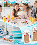 Kids at a party table with 30 Piece Fishing Candy Boxes Set with red and white bobbers and kraft paper tags in use.