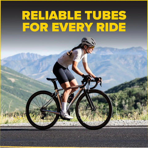 Cyclist riding a bike with mountains in the background, promoting 2 Pack 700C Bike Inner Tubes With 48mm Presta Valve, Butyl Rubber.