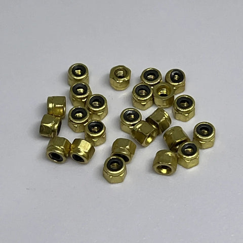 24 Pack Gold Brass Fingerboard Lock Nuts With Nylon Insert shows metallic brass hex nuts for finger skateboard upgrade.