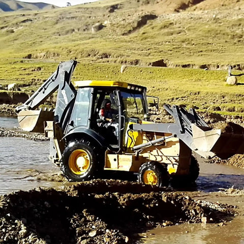 Powerful Backhoe Loader With Attachments For Construction And Farm Use in action on rugged terrain
