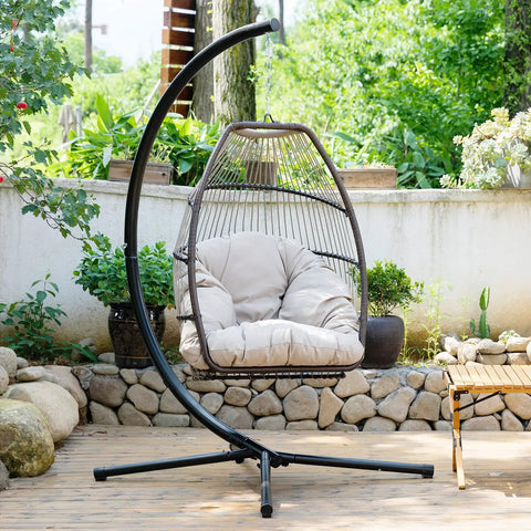 Cozy Outdoor Hanging Egg Chair with Stand and UV Resistant Cushion in a garden setting, showcasing durable steel frame and adjustable cushion.
