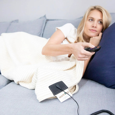 Woman using Grounding Blanket Throw Kit With Ground Therapy Coil Cord, 44 By 68 Inch, Outlet Checker Included, Silver Cotton Polyester Blend