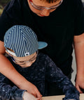 Kids wearing blue safety glasses engaged in outdoor play and STEM activities, showcasing Kids Blue Safety Glasses Lightweight Protective Eyewear For School And Lab Use Comfortable All Day Fit Scratch Resistant For STEM Projects Outdoor Play And Chemistry Experiments.