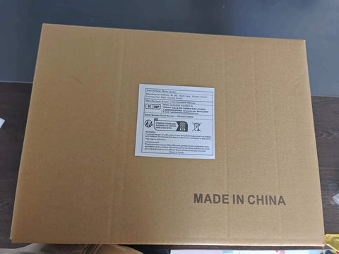 Cardboard box with label and 'Made in China' text on top, placed on a wooden surface.