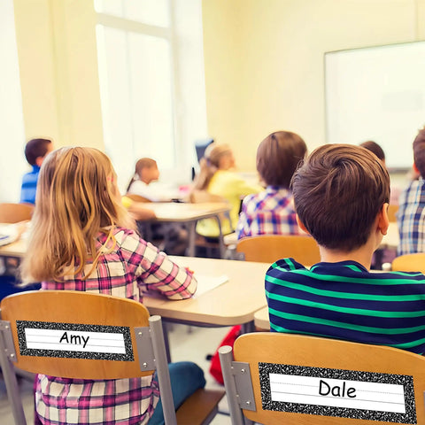 Students in classroom with 36 Piece Composition Desk Name Plates For Classroom 9.5 By 3 Inch Black And White Reusable Name Tags.